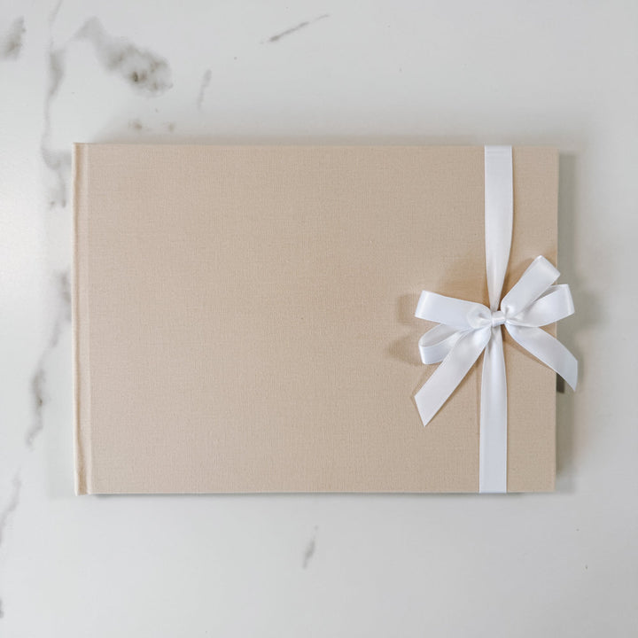 White satin ribbon bow on guest book