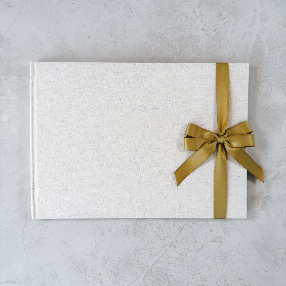 Gold satin ribbon bow on guest book