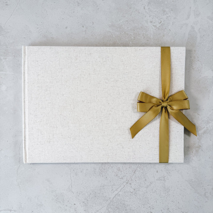 Gold satin ribbon bow on guest book