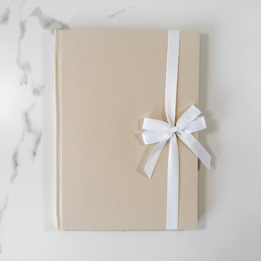 White satin ribbon bow on guest book