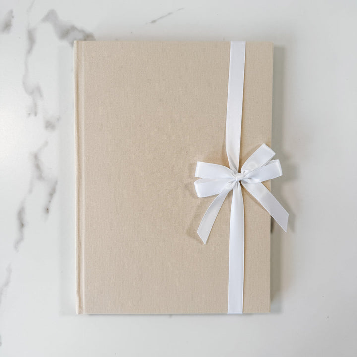 White satin ribbon bow on guest book