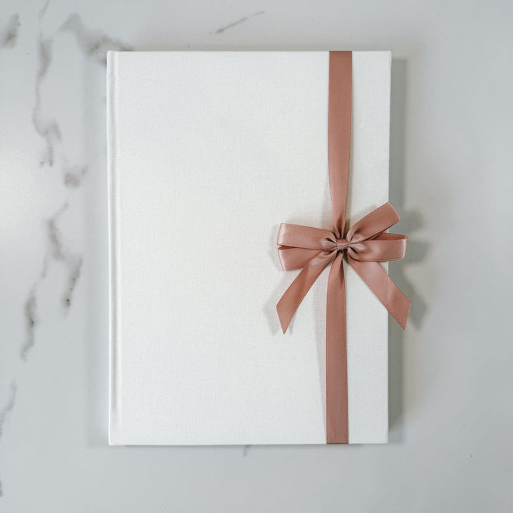 Rose satin ribbon bow on guest book