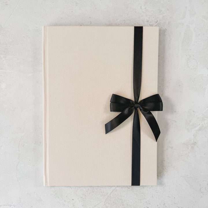 Black satin ribbon bow on guest book
