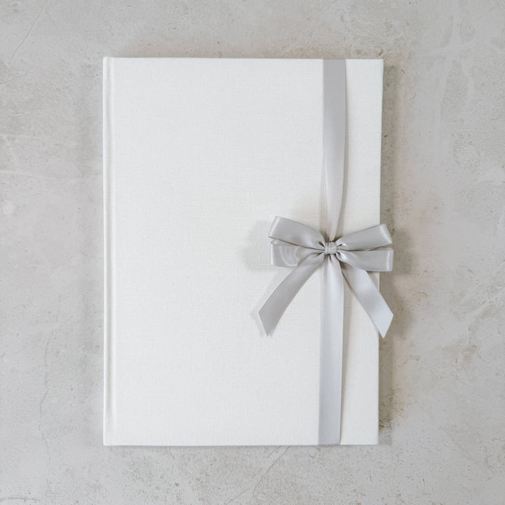 Grey satin ribbon bow on guest book